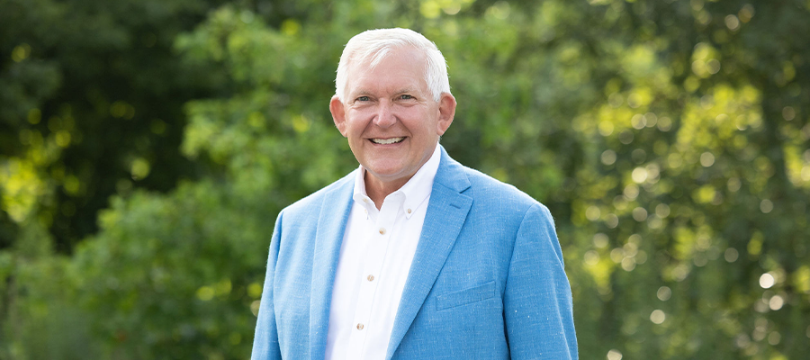 Brad Schroeder wearing a white button-down shirt and a blue suit jacket.