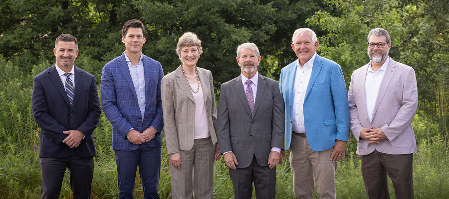 Six members of the 2025–2026 ACRT Services Board of Directors stand outdoors in business attire, arranged left to right: Eric Morales, Charles DeLacey, Nan McClenaghan, Don Esch, Brad Schroeder, and Tony Colly.